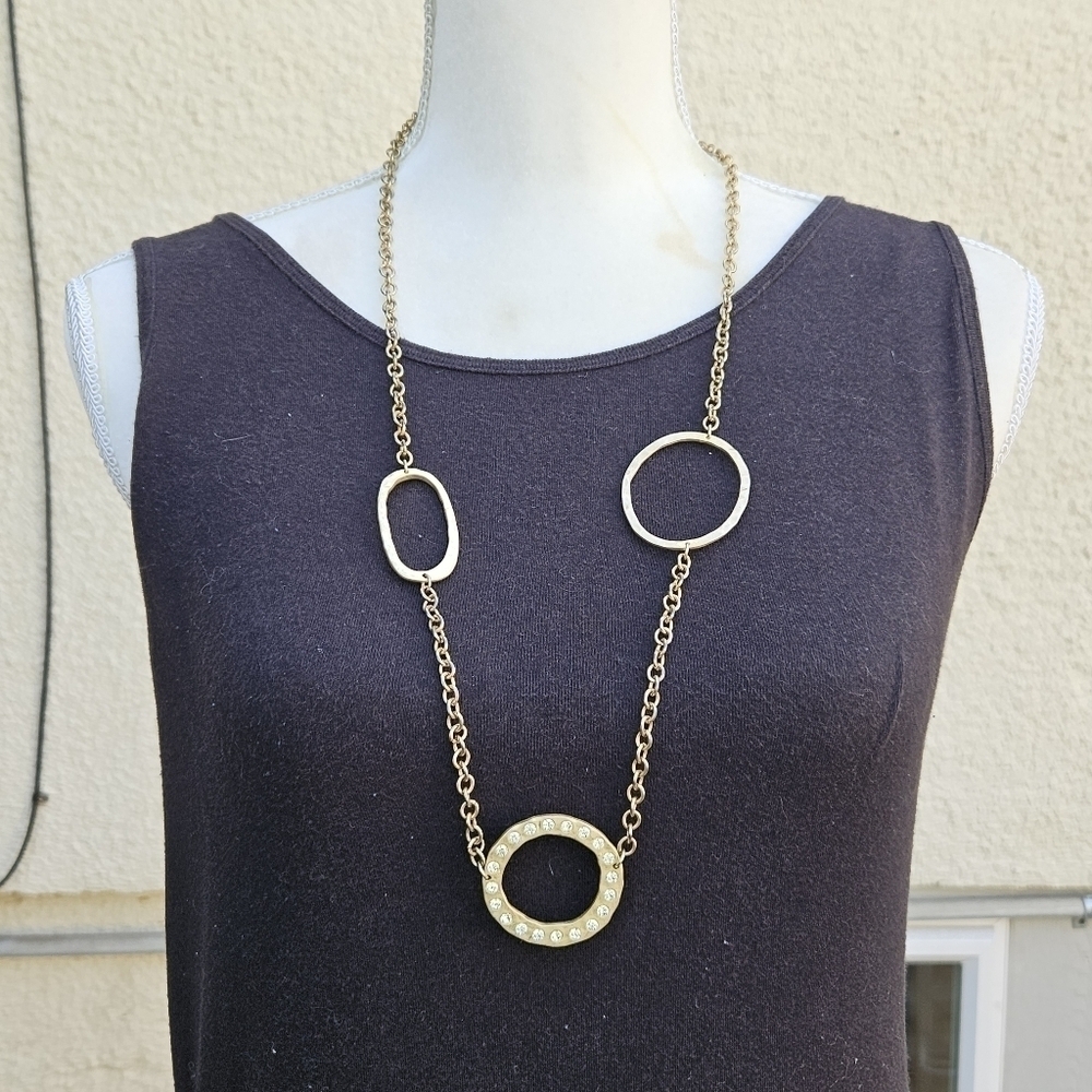 long gold tone chain necklace with hammered and rhinestone loops